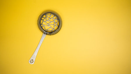 A strainer on a bright yellow backgroundの写真素材