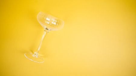 A coupe glass on a bright yellow backgroundの写真素材