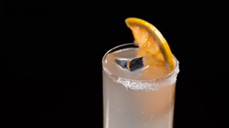 A glass of drink with a ring of salt on a black backgroundの写真素材