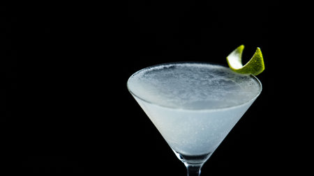 Classic Daiquiri cocktail on a black background with a lime twistの写真素材