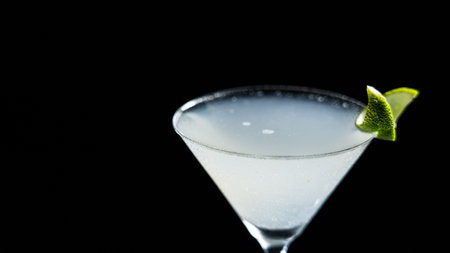 A glass of Gimlat cocktail on a black backgroundの写真素材