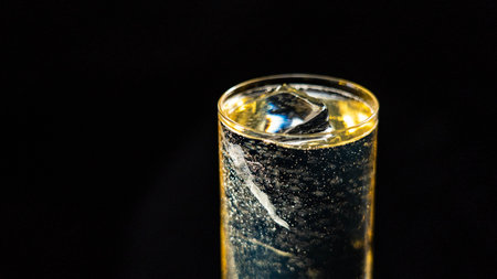 A glass of Highball cocktail on a black backgroundの写真素材