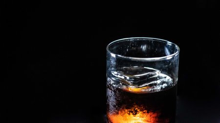 A glass of Black Russian cocktail on a black backgroundの写真素材