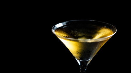Cocktail in a martini glass on a black background.の写真素材