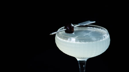 Cocktail with cherry on a black background, close-upの写真素材