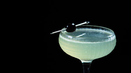Cocktail in a martini glass on a black background.の写真素材