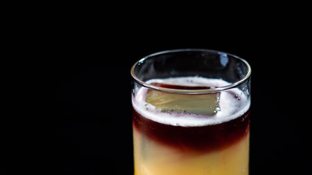 Fruit juice in a glass on a black background. Close-up.の写真素材