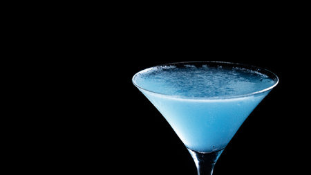 Blue cocktail in martini glass isolated on black backgroundの写真素材