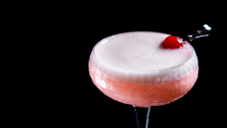 Cocktail with cherry on a black backgroundの写真素材