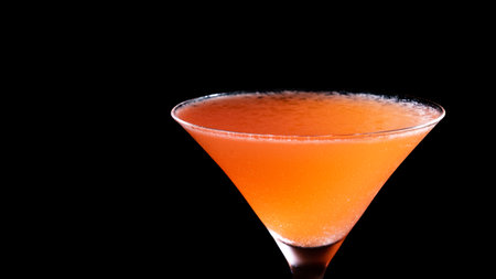 Cocktail in a martini glass on a black background.の写真素材