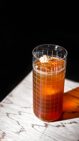 Ice tea in a glass on a wooden table. Black background.の写真素材