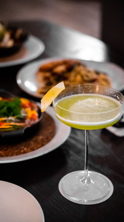 Cocktail in a martini glass on a table in a restaurantの写真素材