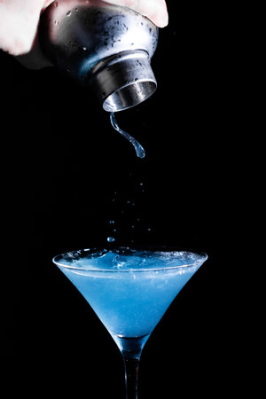 Blue Curacao Cocktail with Shaker and splash on black backgroundの写真素材