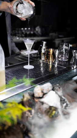 Barman making cocktail at the bar counter in a nightclubの写真素材