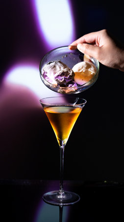 cocktail with ice cream in a martini glass on a dark backgroundの写真素材