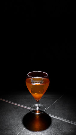 Cocktail in a glass on a black background with reflection.の写真素材