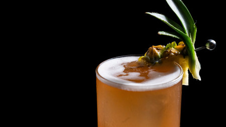 Cocktail with pineapple and ice on a black backgroundの写真素材