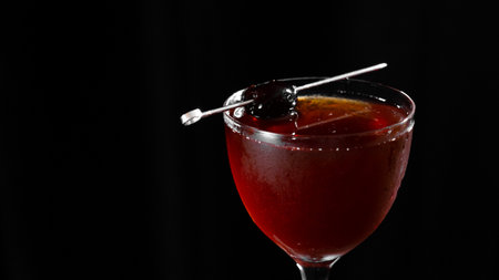 Cocktail in a martini glass on a black backgroundの写真素材