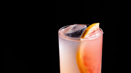 Alcoholic cocktail with grapefruit on a black backgroundの写真素材