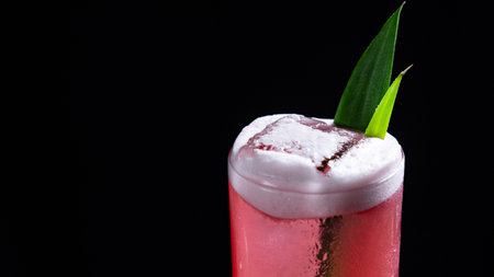 A glass of classic Bay Breeze cocktail on a black backgroundの写真素材