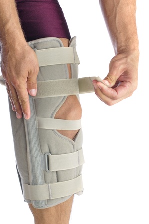 Male athlete wraps his leg with firm supportの写真素材