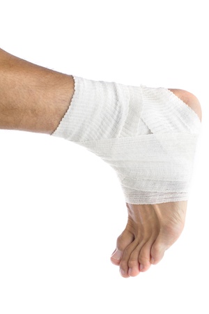 Ankle of male athlete wrapped in white bandagesの写真素材