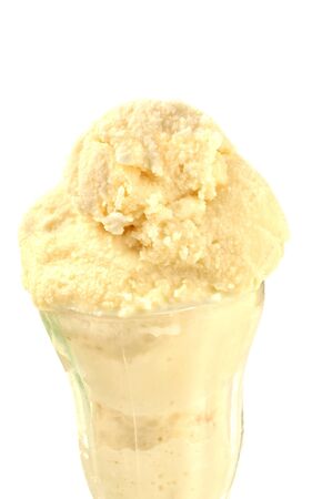 Tall glass of natural vanilla ice cream on white backgroundの写真素材