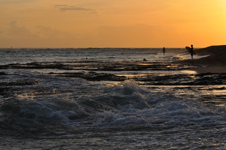 Beautiful golden sunset at Diamond Head Beach, Oahu, Hawaiiの写真素材
