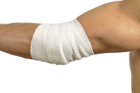 Male elbow injury wrapped with bandage on whiteの写真素材