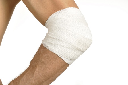 Male elbow wrapped with bandage on whiteの写真素材
