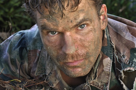 Head shot of military man with muddy faceの写真素材