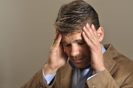 Closeup of man suffering from intense headacheの写真素材