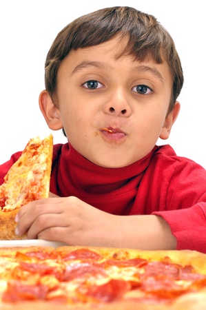Cute little boy loves eating a slice of pizzaの写真素材