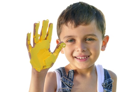 Cute little boy painting yellow with his handの写真素材