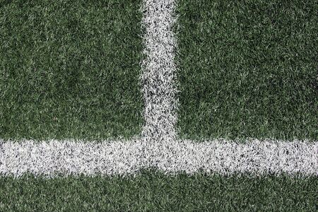 Closeup of white lines on green turfの写真素材