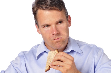 Closeup of man eating a sandwich on white backgroundの写真素材