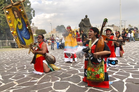 Mexico City, Mexico - December 12, 2012: Performers in traditional Aztec costume sing and play music to celebrate the festival of Our Lady of Guadalupe at the basilica in Mexico City on December 12, 2012.のeditorial素材