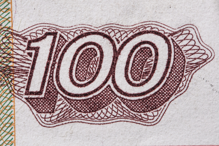 Macro closeup of number 100 on Russian ruble paper currencyの写真素材