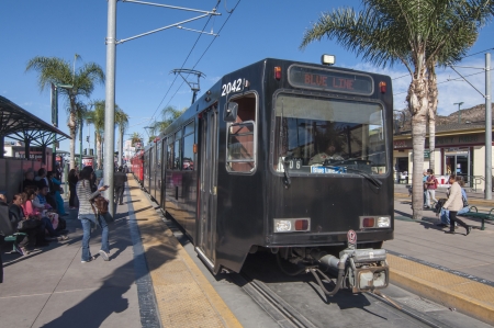 SAN YSIDRO, USA - NOVEMBER 27, 2013  The San Diego blue line trolley arrives at its southernmost destination at the US - Mexico border crossing in San Ysidro   The blue line runs along Interstate 5 making stops between the border and downtown San Diego のeditorial素材