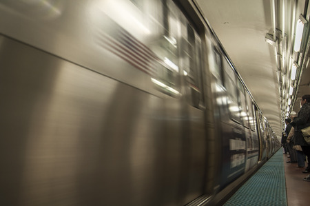CHICAGO, USA - OCTOBER 30, 2013: High speed blue line subway train arrives at the Monroe station during afternoon rush hour in Chicago, Illinois on October 30, 2013.のeditorial素材