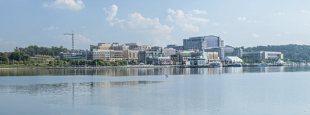 Panoramic of National Harbor riverfront looking across Potomac Riveri in Maryland on sunny dayのeditorial素材