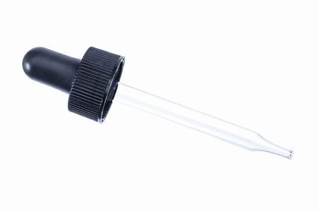 Macro closeup of glass dropper with black rubber top isolated on white backgroundの写真素材