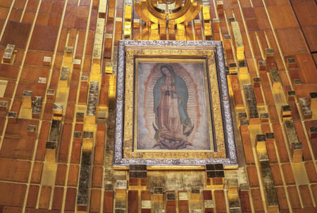 MEXICO CITY, MEXICO - OCT0BER 23, 2014: The original tilma hangs framed behind glass in a shrine behind the altar of the new Basilica of Our Lady of Guadalupe in Mexico Cityのeditorial素材