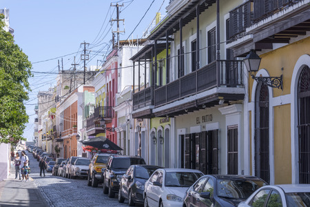 SAN JUAN, PUERTO RICO - JANUARY 29, 2014: Parked cars line a narrow brick street with old colonial-style buildings in historical Old San Juan, Puerto Ricoのeditorial素材