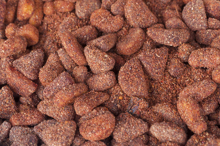 Bin of preserved fruit pieces covered with chili and salt granules in Mexican marketの写真素材
