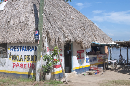 TONALA, MEXICO - JULY 20, 2014: Traditional cuisines are prepared under the palm thatched roof of El Ancla Perdida restaurant on the shore of theTonala River in Tonala, Veracruz, Mexicoのeditorial素材