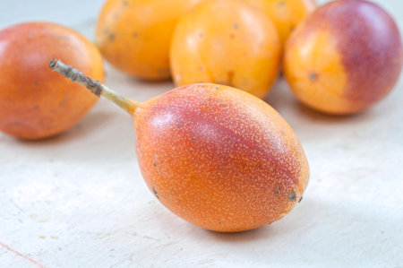 Fresh ripe Passiflora ligularis granadilla fruit on wooden tableの写真素材