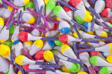 Closeup pile of colorful spark throwing Mexican firecrackers with purple fusesの写真素材
