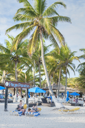 TULUM, MEXICO - JANUARY 23, 2015: Tourist enjoy the sunny warm winter weather at the white sand beach of Playa Paraiso in Tulum on the Mexican Rivieraのeditorial素材