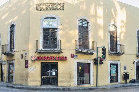 MERIDA, MEXICO - JANUARY 19, 2015: A Burger King restaurant occupies an old rustic colonial style building in on a street corner in downtown Merida, Yucatanのeditorial素材